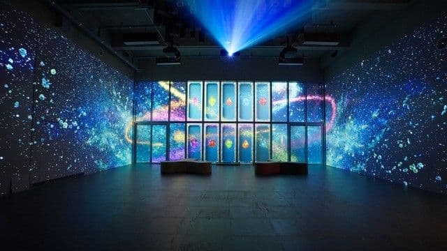 Osam's Treasure Chest zone — projection-mapped gem constellations across the walls
